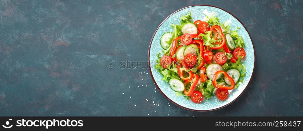 Healthy vegetarian vegetable salad of fresh lettuce, cucumber, sweet pepper and tomatoes. Vegan plant-based food. Flat Lay. Top view. Banner