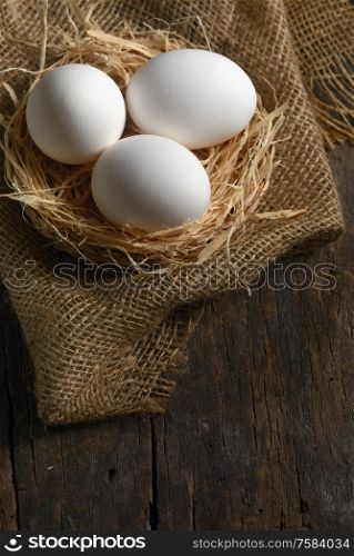 Healthy white farm fresh eggs in nest