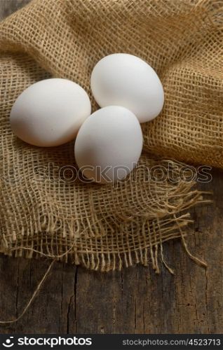 Healthy white farm fresh eggs on sack
