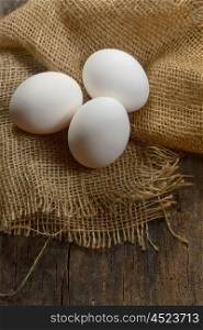Healthy white farm fresh eggs on sack