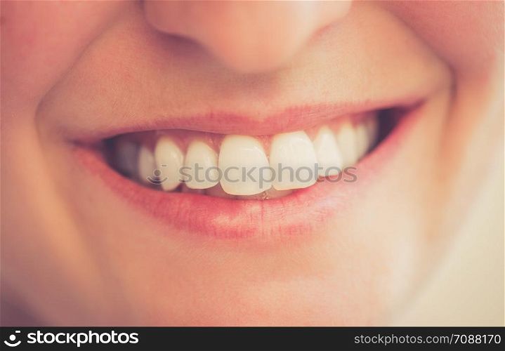 Healthy white teeth of a young woman, close up picture