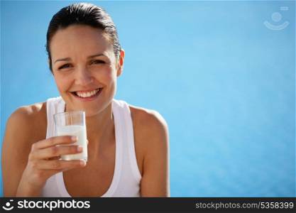 Healthy woman drinking a glass of milk