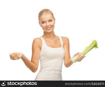healthy woman holding bunch of celery and vitamins