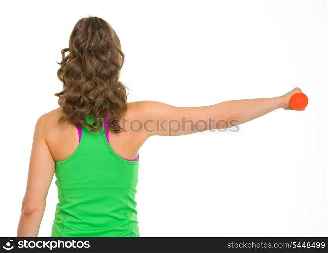 Healthy woman making exercise with dumbbells . rear view