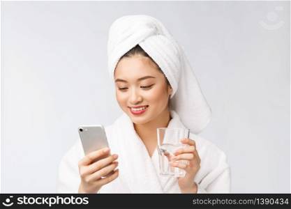Healthy young beautiful woman drinking water, beauty face natural makeup with holding mobile phone, isolated over white background. Healthy young beautiful woman drinking water, beauty face natural makeup with holding mobile phone, isolated over white background.