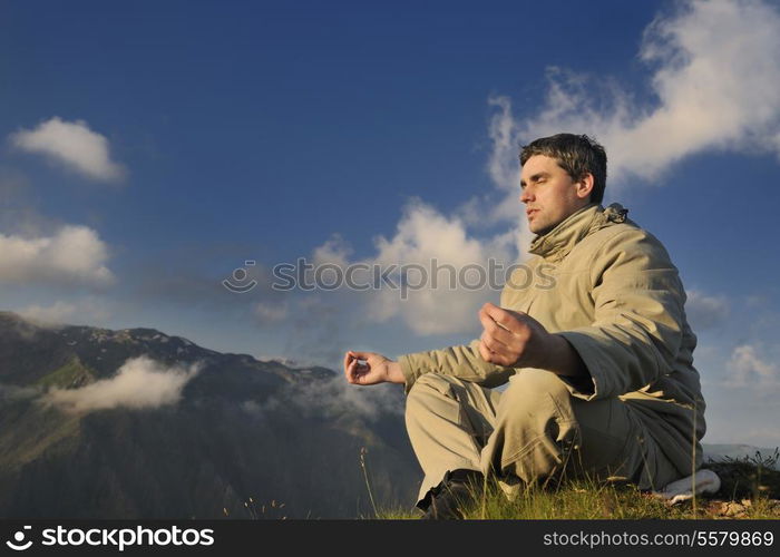 healthy young man practice youga in height mountain at early morning and sunrise