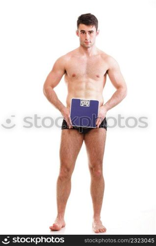 Healthy young man with a weight scale. Isolated over white background