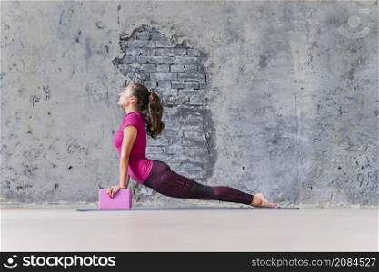 healthy young woman exercising fitness push ups using blocks
