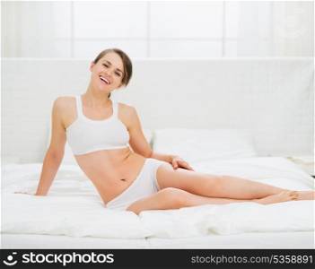 Healthy young woman laying in bed
