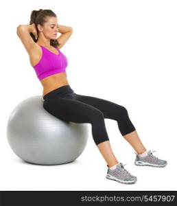 Healthy young woman making exercise on fitness ball