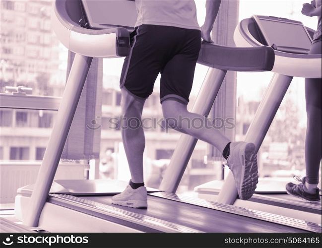 healthy yung sportsman exercise jogging on treadmill in fitness gym