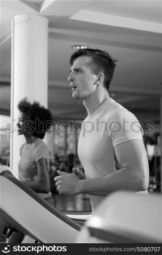 healthy yung sportsman exercise jogging on treadmill in fitness gym