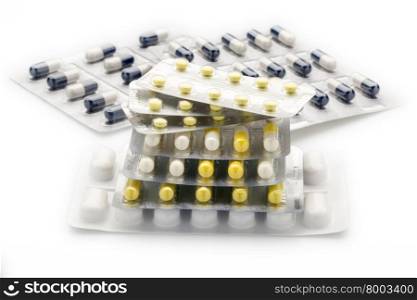 Heap blister packs of colorful pills and capsules. Heap of blister packs of colorful pills and capsules on white background