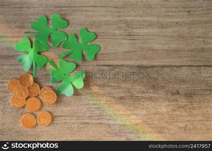 heap coins green paper clovers board