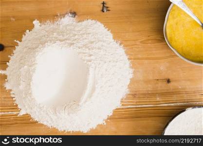 heap flour near mixed eggs