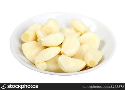 Heap of a pieces garlics of white plate. Isolated on white background. Close-up studio photography.