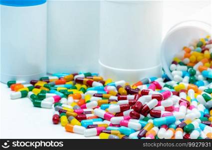 Heap of antibiotic capsule with plastic bottle. Antibiotic drug resistance concept. Antibiotic drug overuse and smart use concept. Pharmaceutical industry. Pharmacy product. Prescription drugs.