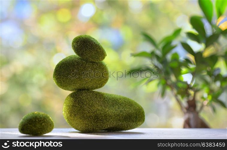Heap of balanced stones with moss