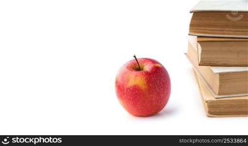 Heap of books with apple isolated on white background