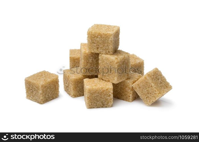 Heap of cane sugar cubes close up isolated on white background