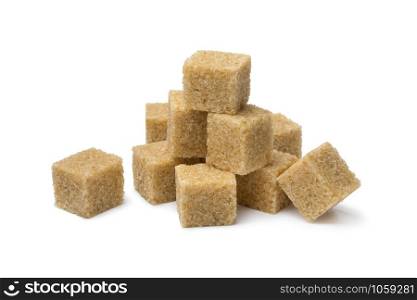 Heap of cane sugar cubes close up isolated on white background