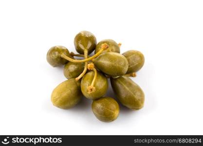 Heap of canned capers on a white background