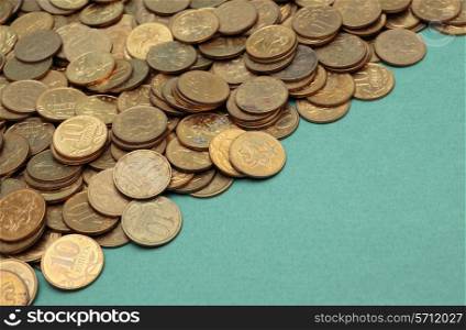 heap of coins on a green background