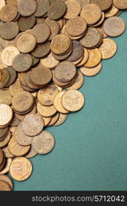 heap of coins on a green background