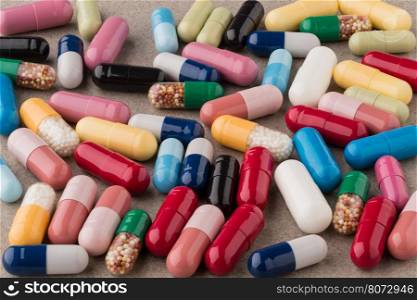 Heap of colorful drugs and pills. Heap of colorful drugs and pills on textured background