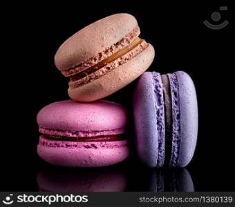 Heap of colorful macaroons on black background. Heap of colorful macaroons on black