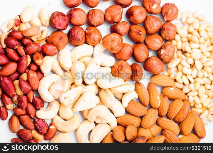 Heap of different nuts on white