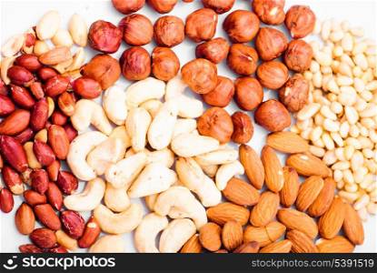 Heap of different nuts on white