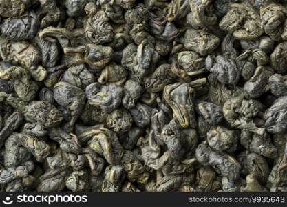 Heap of dried chinese green gunpowder tea close up full frame as background