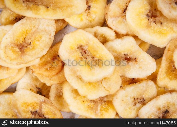 Heap of dried organic banana chips as natural snack for dessert. Dried banana chips as natural snack for dessert