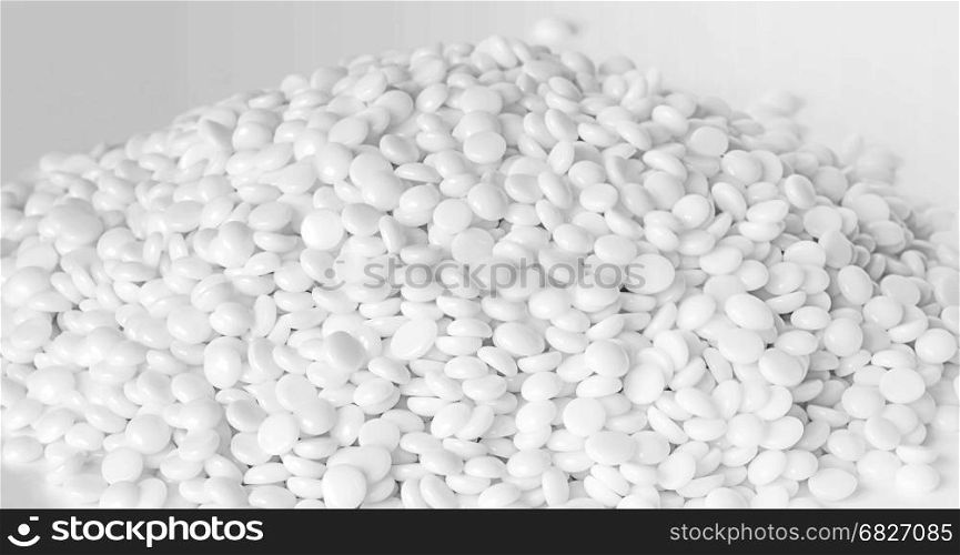 Heap of fine white thermoplastic granules on the white background
