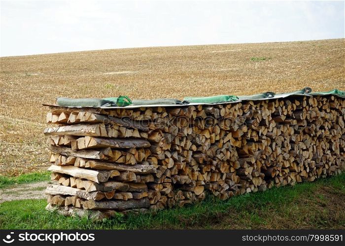 Heap of firewood on the farm field in Swabia, Germany