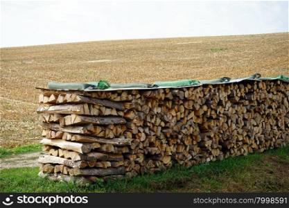 Heap of firewood on the farm field in Swabia, Germany