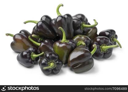 Heap of fresh raw mini purple bell peppers isolated on white background