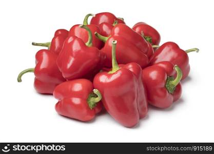 Heap of fresh raw mini red bell peppers isolated on white background