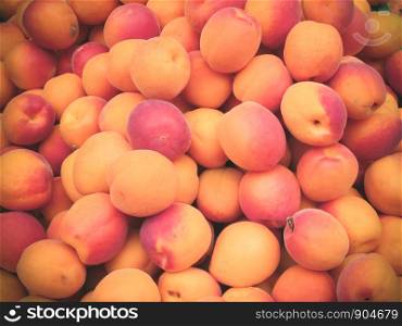 Heap of fresh ripe peaches for sale at the market.