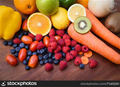 Heap of fresh tropical fruits colorful and vegetables summer healthy foods / Many ripe fruit mixed on wooden background