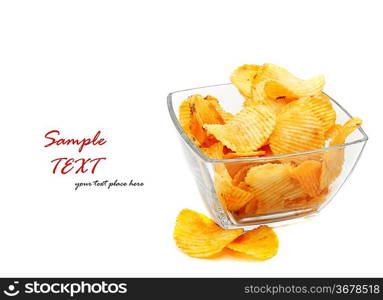 Heap of fried potato chips in glass bowl on white background.