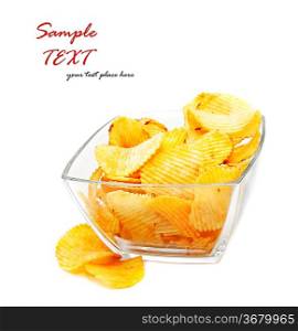 Heap of fried potato chips in glass bowl on white background.