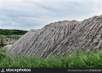 heap of gravel with water stains from rain on a background of blue sky careers