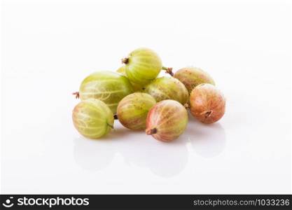 heap of green gooseberries isolated on white background