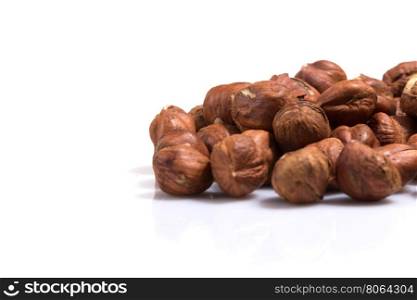 Heap of hazelnuts isolated on white background, macro image