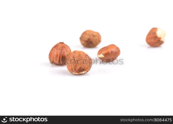 Heap of hazelnuts isolated on white background, macro image