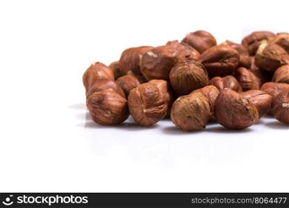 Heap of hazelnuts isolated on white background, macro image
