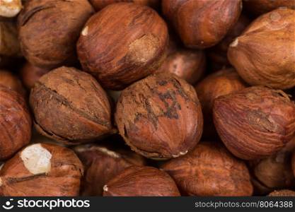 Heap of hazelnuts nuts background, macro image