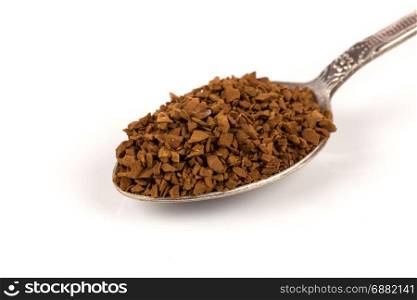 Heap of instant coffee in spoon isolated on white background